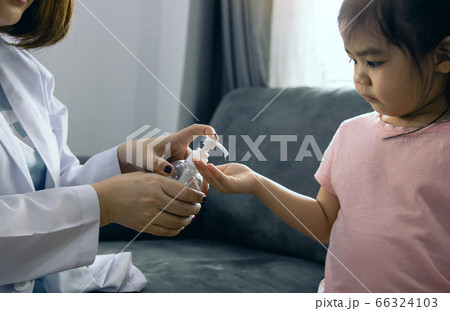 Female pediatrician is holding a bottle of alcohol 66324103