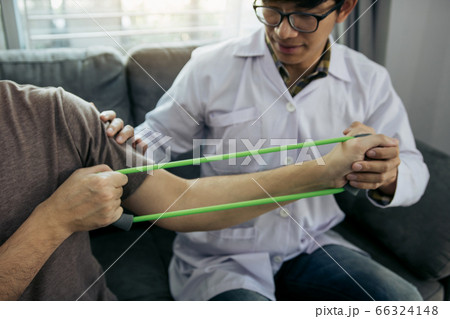Asian male physical therapist descent working and 66324148
