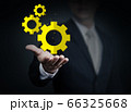 Close up of businessman holding gear mechanism in 66325668
