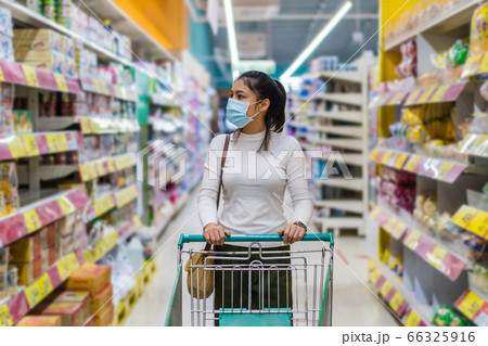 asian woman with shopping cart in supermarket 66325916