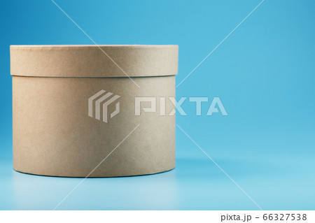 Round cardboard box on a blue background, free Round cardboard box on a blue background, free 66327538