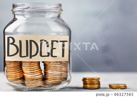 Glass Jar with gold coins and a sticker saying Glass Jar with gold coins and a sticker saying 66327565