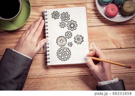 Businesswoman sketching in notepad Businesswoman sketching in notepad 66331658