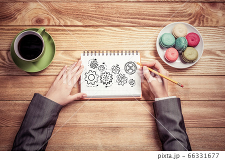 Businesswoman sketching in notepad Businesswoman sketching in notepad 66331677