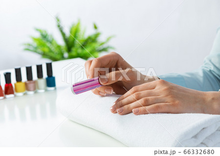 Woman using nail file and create nails shape 66332680