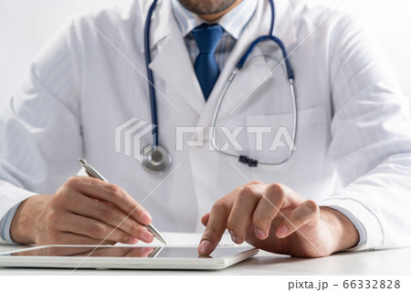 Close up of doctor hands using tablet computer Close up of doctor hands using tablet computer 66332828