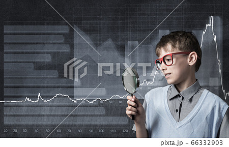 Curious school boy with magnifier 66332903