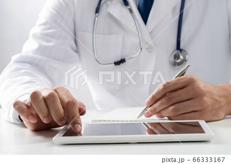 Close up of doctor hands using tablet computer Close up of doctor hands using tablet computer 66333167