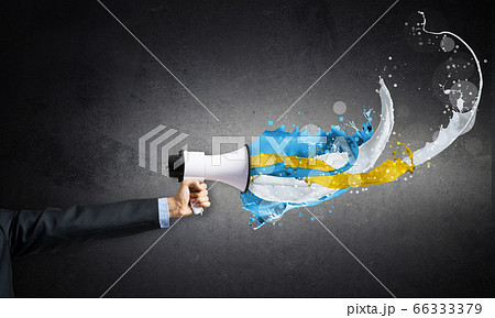 Businessman hand holding megaphone on wall 66333379