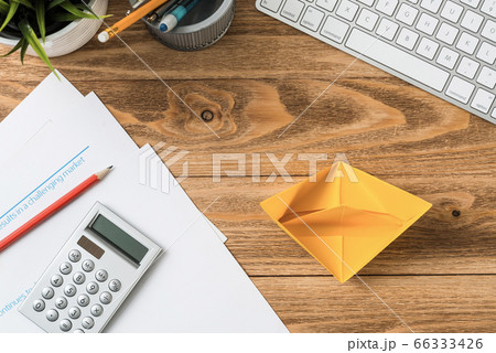 Top view office workspace with orange paper ship Top view office workspace with orange paper ship 66333426