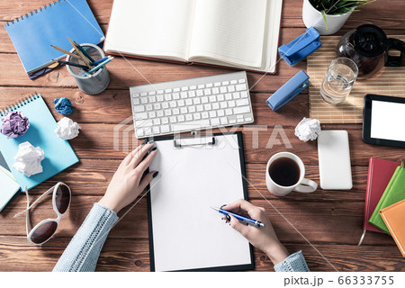 Businesswoman writing on white paper with pen Businesswoman writing on white paper with pen 66333755