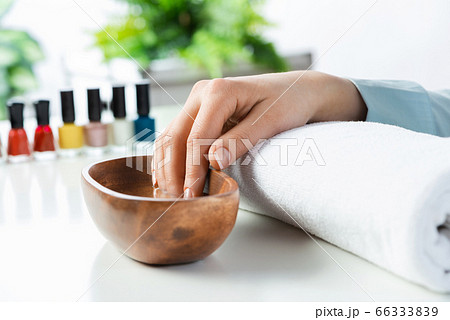 Closeup female hands in wooden bowl with water 66333839
