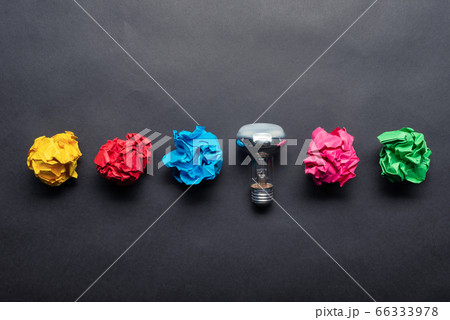 Lightbulb and crumpled colorful paper balls 66333978