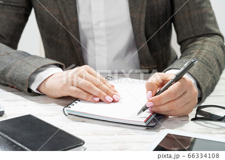 Close up woman hand holding pen 66334108