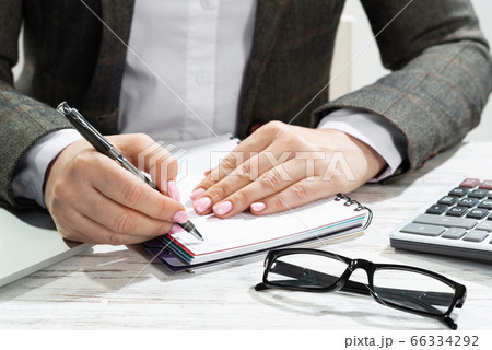 Close up woman hand holding pen 66334292