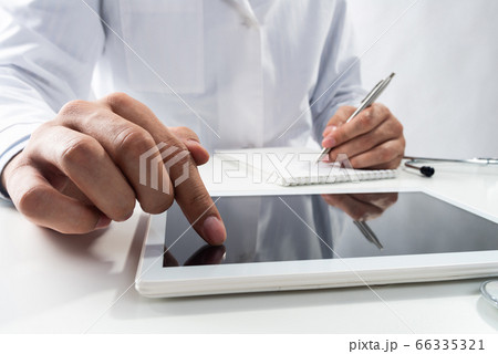 Close up of therapist hands using tablet computer Close up of therapist hands using tablet computer 66335321