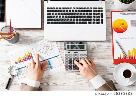 Businessman working at office desk with data Businessman working at office desk with data 66335338
