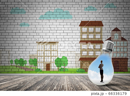 Businesswoman trapped in bulb Businesswoman trapped in bulb 66336179