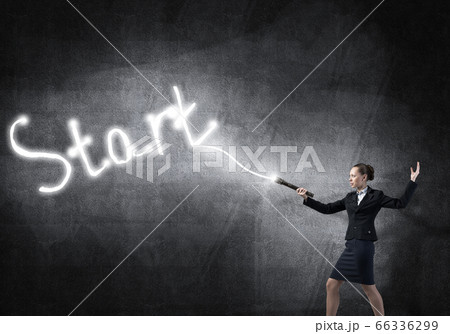 Woman with flashlight in hand 66336299