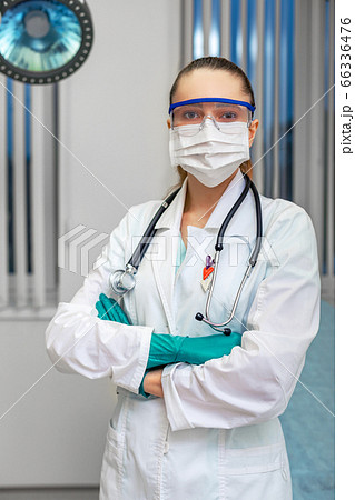 Personal protective equipment, woman doctor in personal protective equipment on the background of a hospital ward. Copy space. Personal protective equipment, woman doctor in personal protective equipment on the background of a hospital ward. Copy space. 66336476