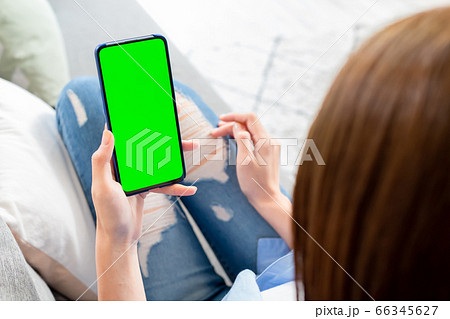 woman hold green screen smartphone 66345627