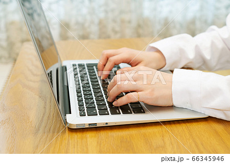 ノートパソコンと女性の手元 66345946