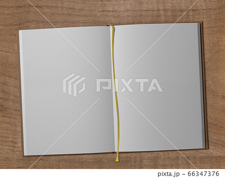 木製の机に栞で開いた白い本、自由な物語が描けます。 66347376