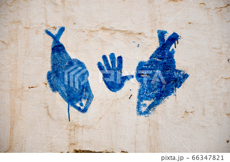 MATMATA, TUNISIA - February 03, 2009: Picture of a hand and fish symbol on traditional berber house wall in the sahara 66347821