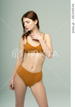young beautiful girl pose in brown underwear in studio young beautiful girl pose in brown underwear in studio 66349540