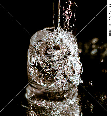 Splashes and drops of water in a glass are 66352333
