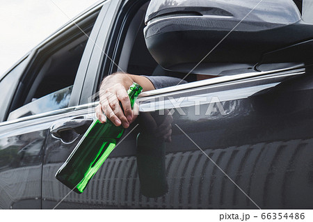 Close up of bottle, Young asian man drives a car 66354486
