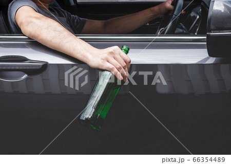 Close up of bottle, Young asian man drives a car 66354489