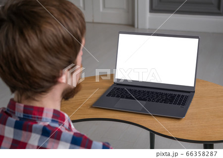 Man looking at laptop with white empty display Man looking at laptop with white empty display 66358287