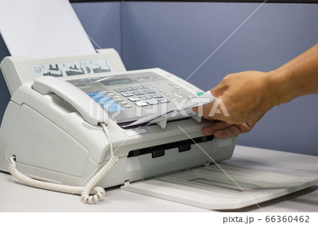hand man are using a fax machine in the office Business concept hand man are using a fax machine in the office Business concept 66360462