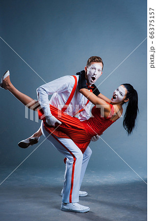 two funny mimes isolated on gray background 66375157