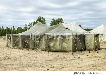 old soldiers ' tents torn in the wind in the field 66376625