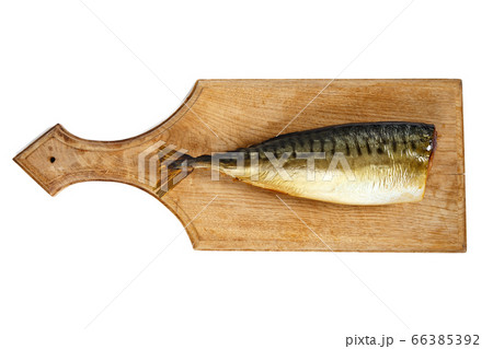 Photo of smoked headless mackerel on kitchen wooden board 66385392