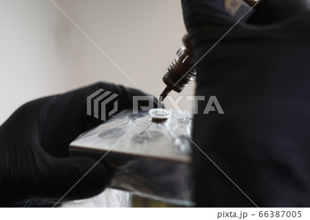 Hands in black gloves choose color eyebrow paint 66387005