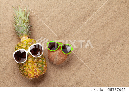 Pineapple and coconut with sunglasses Pineapple and coconut with sunglasses 66387065