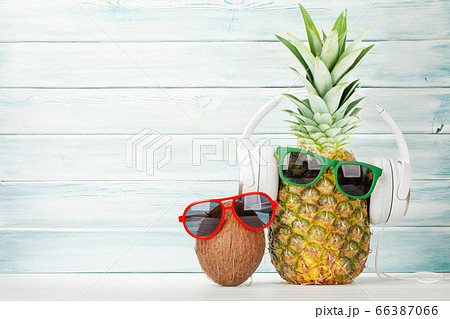 Ripe pineapple and coconut with sunglasses and Ripe pineapple and coconut with sunglasses and 66387066