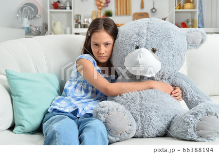 Sad little girl with toy bear in facial mask Sad little girl with toy bear in facial mask 66388194
