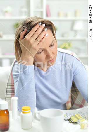 Portrait of beautiful young woman with headache Portrait of beautiful young woman with headache 66388302