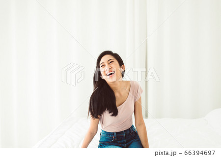 Beautiful young asian woman laughing while sitting at home,Relaxing time 66394697