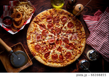 pepperoni pizza with french fries and onion rings 66398855