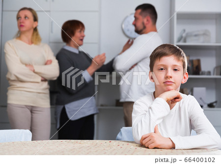 Upset son suffering from parental arguing Upset son suffering from parental arguing 66400102