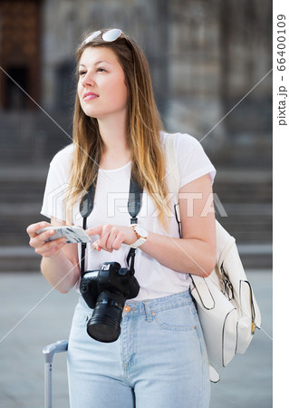 Woman looking for the map in the phone 66400109