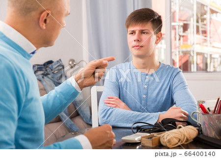 Serious father lecturing his son Serious father lecturing his son 66400140