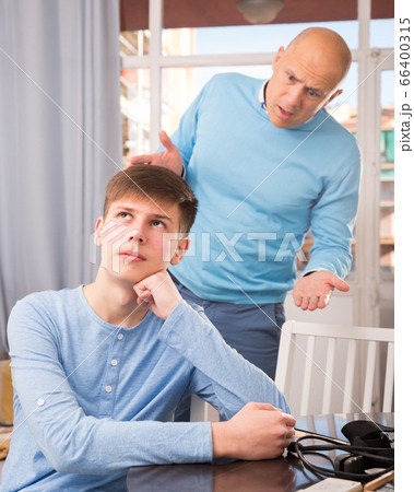 Father quarreling with his son 66400315
