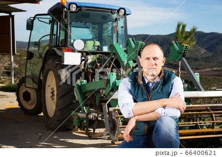 Man near tractor in vineyard 66400621