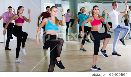 joyous men and ladies dancing aerobics at lesson 66400664